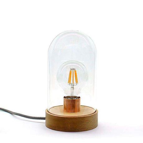 Una luminaria evocadora del recuerdo de décadas pasadas, una lámpara que muestra la simplicidad del primer emisor de luz. Una bombilla filamentosa ególatra, protegida por un fanal de vidrio.