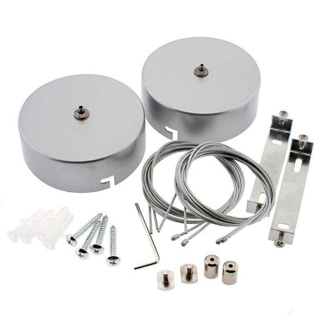 Kit de suspensión que incluye: dos florones redondos de calor silver Ø100x40mm, dos cables de acero con accesorios de sujección al perfil suspendido y tornillos de sujección a techo.