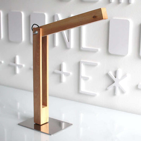 La lámpara de mesa CARFI en una Lámpara Led de Mesa fabricada en madera de aliso y luminaria led con sensor táctil y regulador de intensidad. Con una altura de 40cm y totalmente orientable en cualquier posición.
