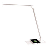 Lámpara de escritorio de brazo abatible y luminaria led de de alta potencia, botonera táctil con selector de intensidad. Con un diseño estilizado, moderno y funcional, realizado con materiales de alta calidad, su brazo articulado permite dirigir su haz de luz en cualquier dirección. Incorpora cargador inalámbrico IQ en la base. 
